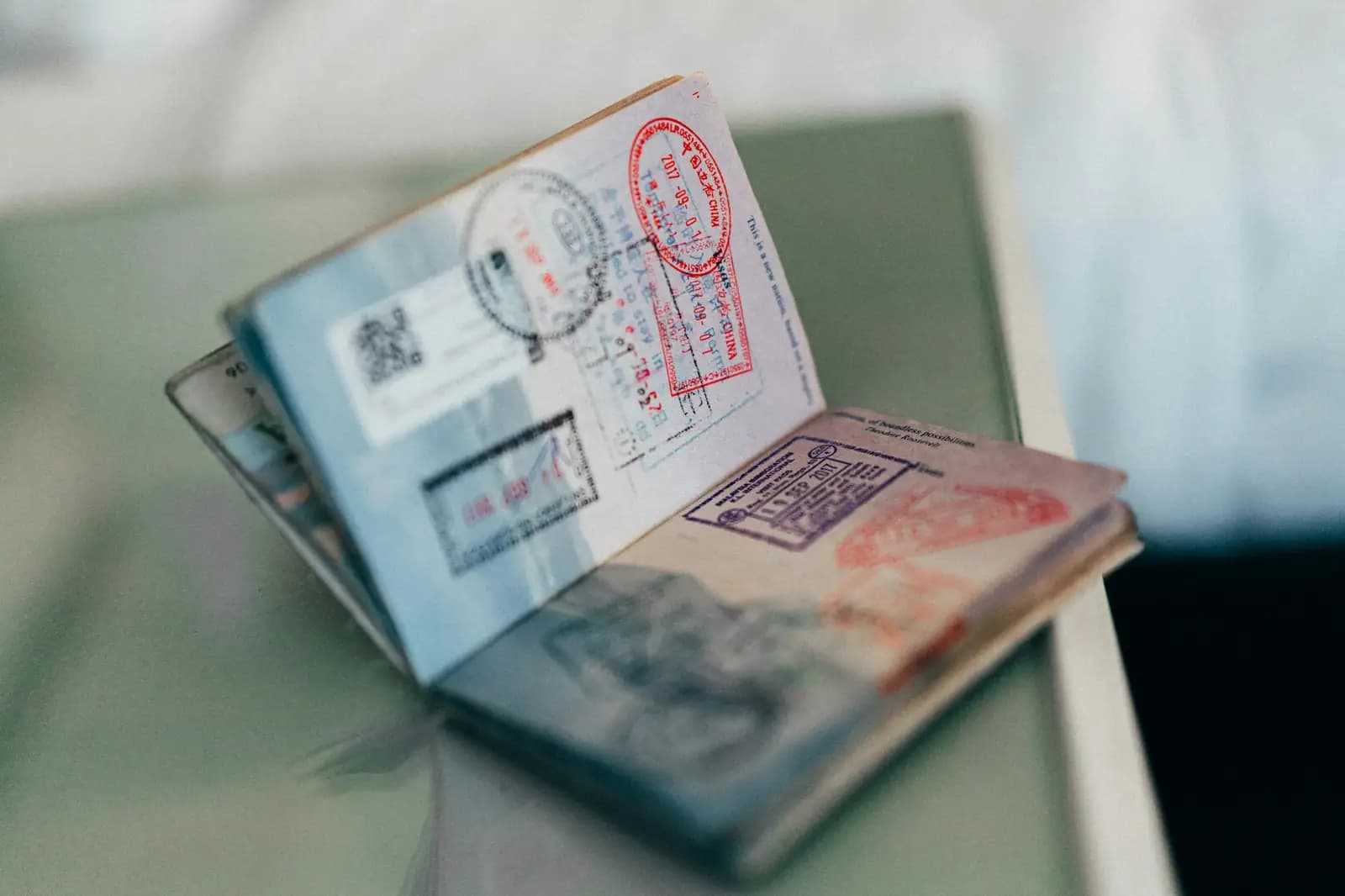 An open passport filled with colorful entry stamps